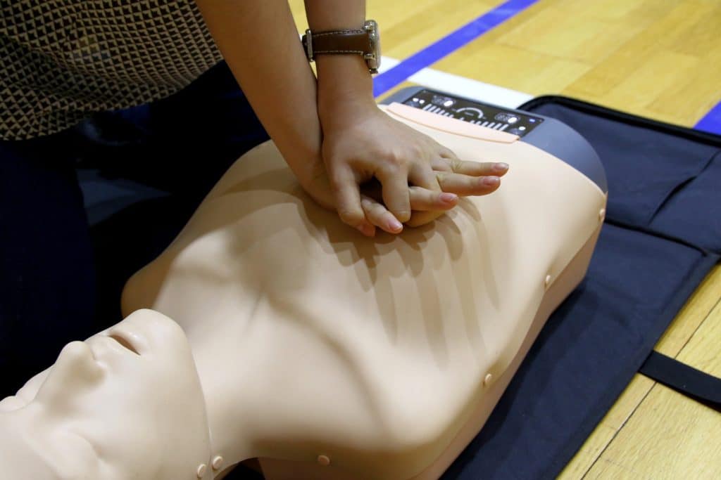 Student performing CPR on a mannequin